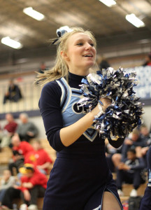 At the court warming basketball game on Friday, Feb. 1, senior Allison Pinet cheers the team on.  Pinet was the captain of the squad this year. “My favorite part of cheer is competing at regionals and state. I’ll miss cheerleading all around, but mostly just summer practices and football games,” Pinet said.