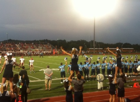 The football team and cheerleaders wait for the kick off of the first home game of the 2014 football season.