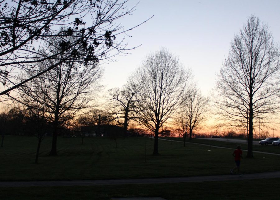 People at the park run and walk on a nice spring night at Oak Grove Park.