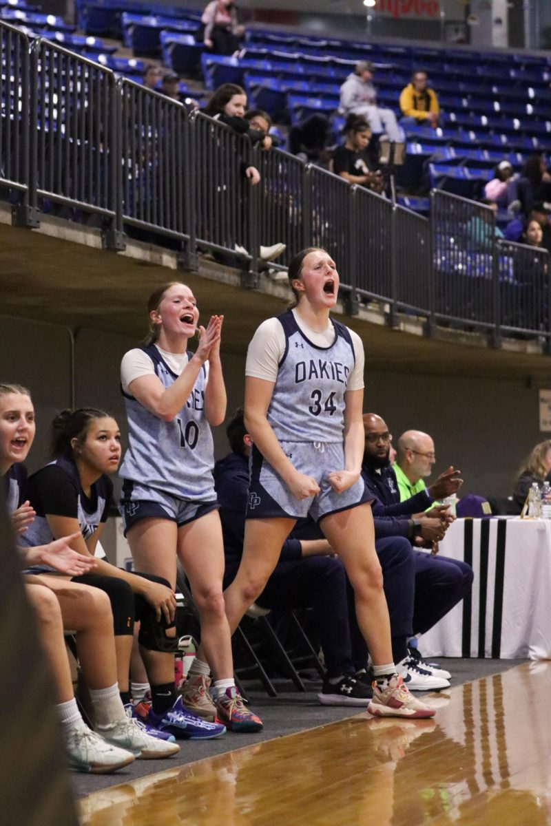 Junior Sierra Geary and senior Lilli Everley scream after their teammate scores on a layup during the preseason jamboree on Tuesday, Nov. 19. "I think that we have a great group of girls and we're working very hard. I think that we're gonna have a great year. with lots of results." The Oakies played their first regular season game Monday, Nov. 25 against Raytown and won the game 69-30.