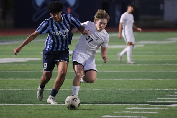 Monday, Oct. 28, freshman Beto Lopez dribbles he ball against a Northtown player. Oak Park lost 2-3. Players were upset as OP was on a losing streak.  