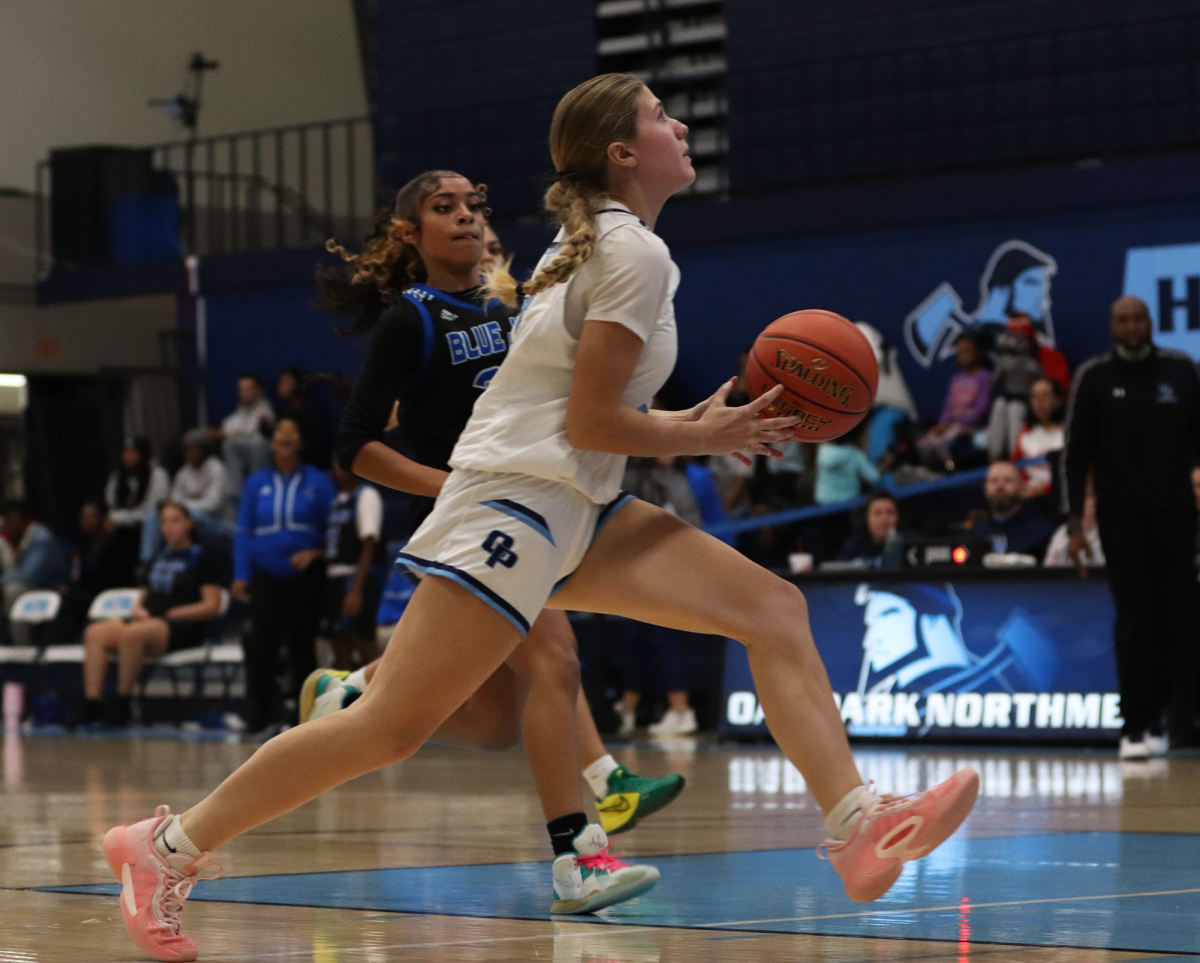 Kailah dribbled the ball past an opposing player during the basketball game vs Raytown.