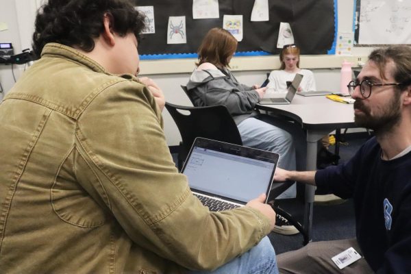 Sophomore Jaden Williams asks math teacher Austin Patek for help on the new material that is in the geometry benchmark. “I didn't know any of it so I decided to ask Patek for help.“ 