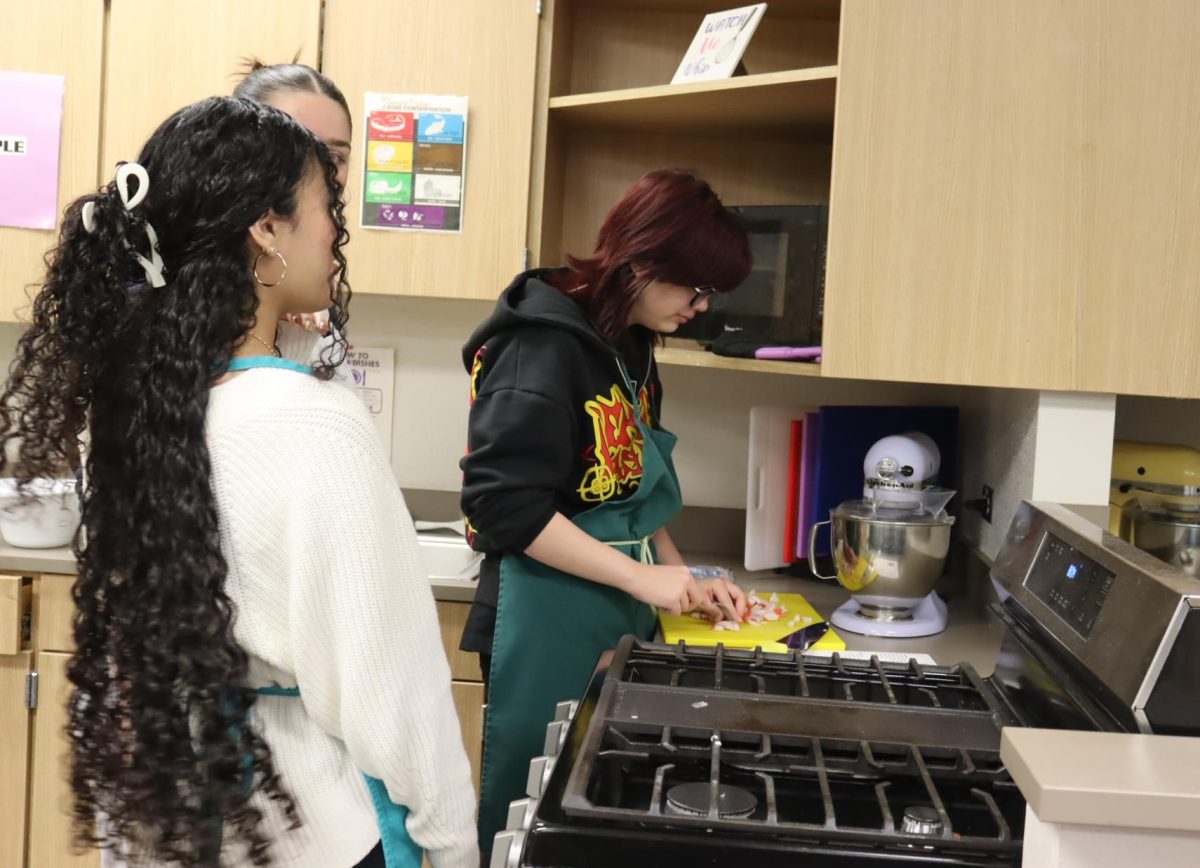 Kimmy Ferman and Star Grenado cut up the food on the cutting board. “I like that I get to explore different countries,” Ferman said when talking about her favorite part of the class. 