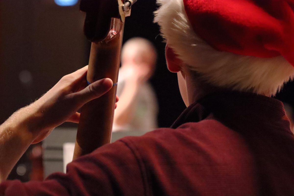 On Thursday, Dec. 5, junior Luke Robinett plays his bass looking toward his director Erick Theno. This is the symphonic orchestra, the elite of string instruments. They played “Plowing Through the Snow” at this part of their Christmas concert. Which is why there’s a Santa hat. “I thought we did really good,” Robinett said. “We’ve been working a lot on intonation, recently, which really, I think really helped. And then I think just kind of the work we’ve put in, we’ve all been on the same page, just working hard.”