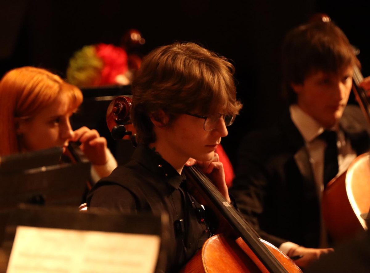 Junior Nate Johnson performs with the symphonic orchestra, playing cello. “I think we did pretty good.” Symphonic performed three songs at the annual winter concert on Friday, Dec. 6.