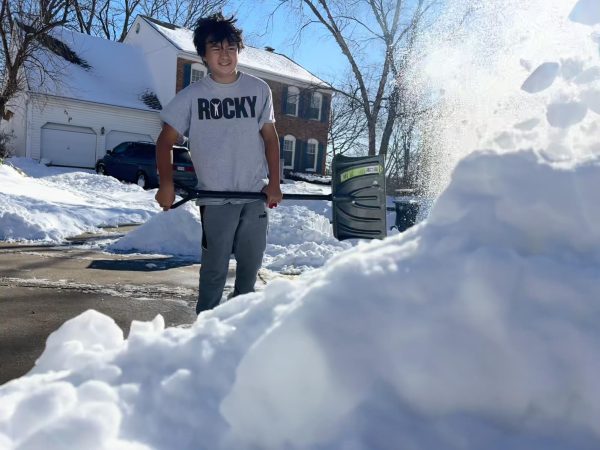 On Wednesday, Jan. 8, NKC Schools student Ryker Nakahodo begins to shovel his driveway by throwing it atop a pile. He did all this in the hope that shoveling snow would earn some money. He also didn't want to change into winter gear because wanted to get out there and do a quick job. “Because I don't want my Mom to slip and die in the car or Silva [our neighbor]," Nakahodo said.
