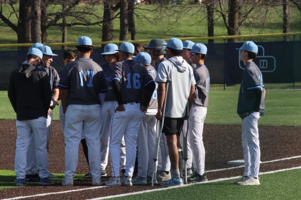 Oak Park C-Team baseball have a post-game meeting after losing to the Staley Falcons 17-0.