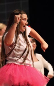 Freshman Bela Riggle dances to "We Don't Talk About Bruno" in the Oak Park choir concert. Riggle has been singing for her whole life and said her friends keep her motivated. 