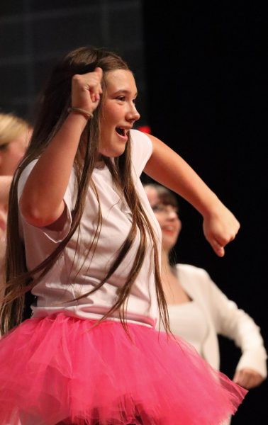 Freshman Bela Riggle dances to "We Don't Talk About Bruno" in the Oak Park choir concert. Riggle has been singing for her whole life and said her friends keep her motivated.