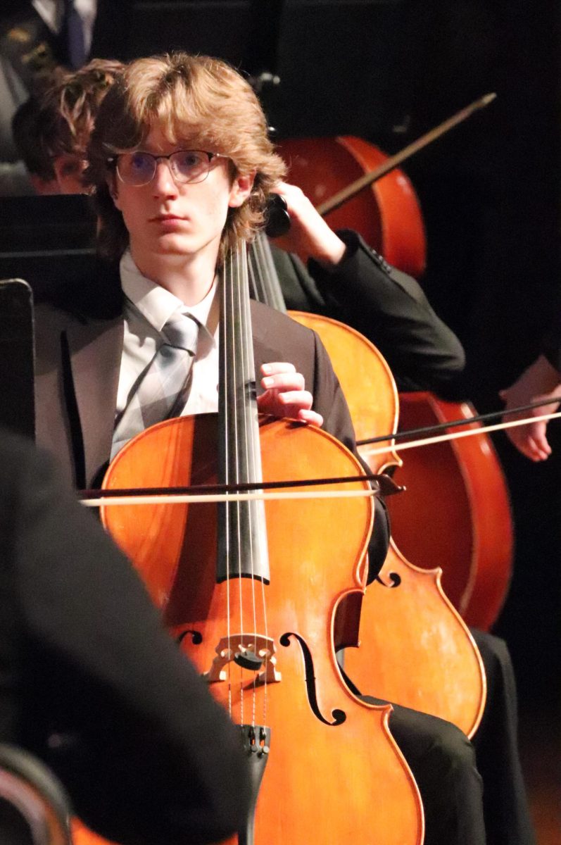 Senior Nathan Johnson sits among his peers at the April 28th end of year concert, awaiting the directors word to begin playing. 