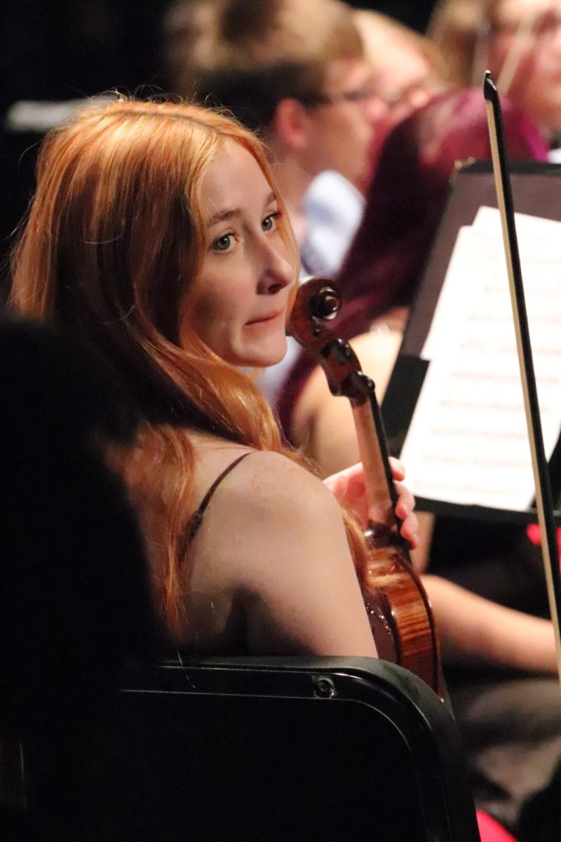 Watching on wistfully, Senior Sophia Johnson waits in her seat, about to play the final notes of her orchestra career at Oak Park during their end of year concert.