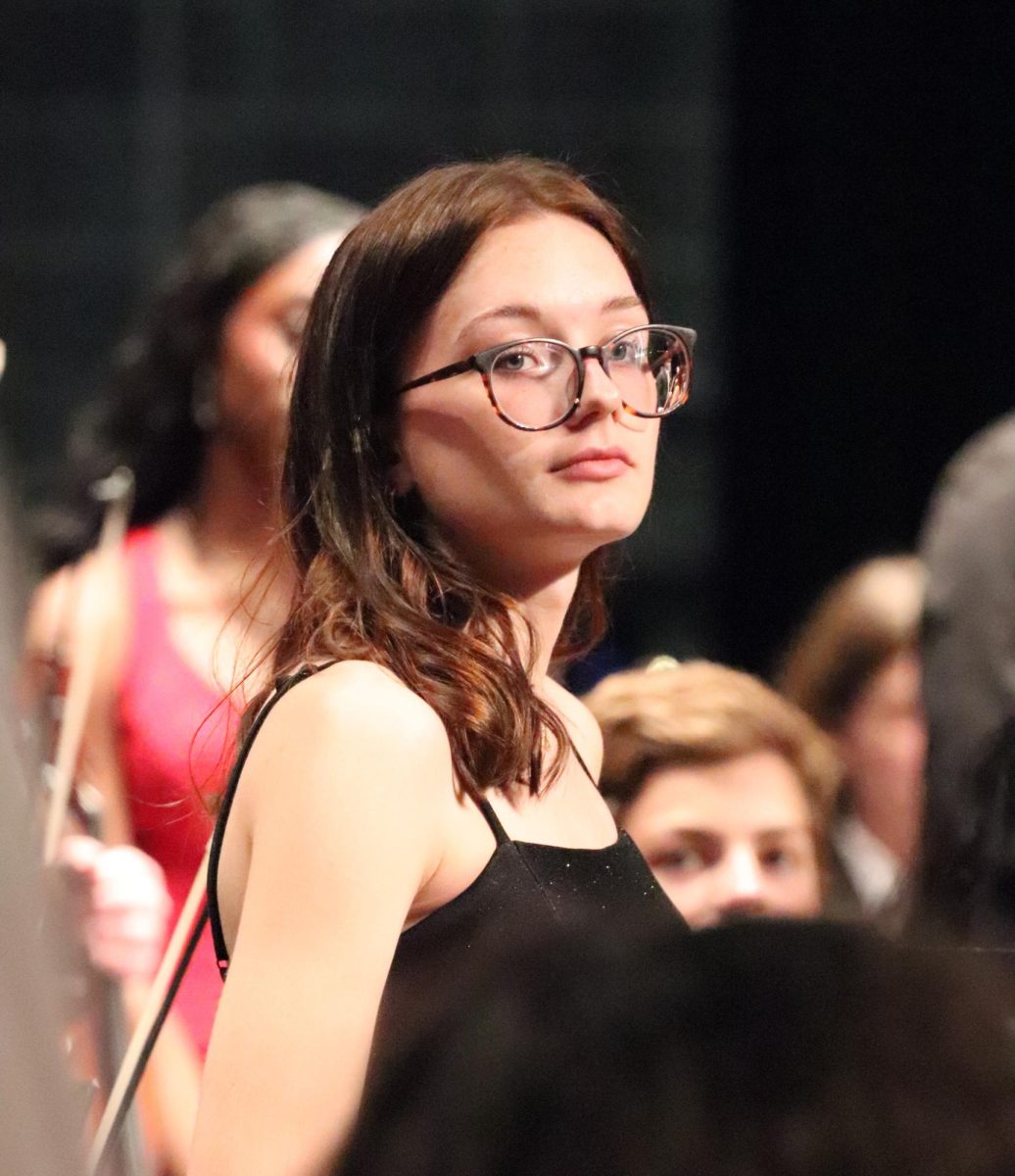 Senior Emily Kitchen watches as the orchestras director, Eric Theno gives a touching recognition speech in honor of the Seniors during their last concert on April 28th, around 7PM.  